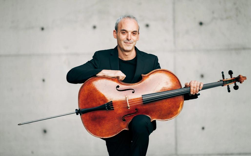 A man holding a cello